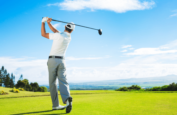 Man with country club membership in Singapore playing golf.